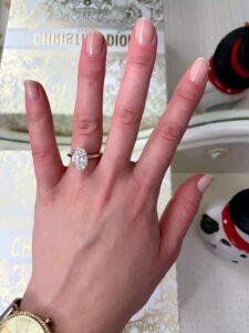 Oval diamond ring on finger